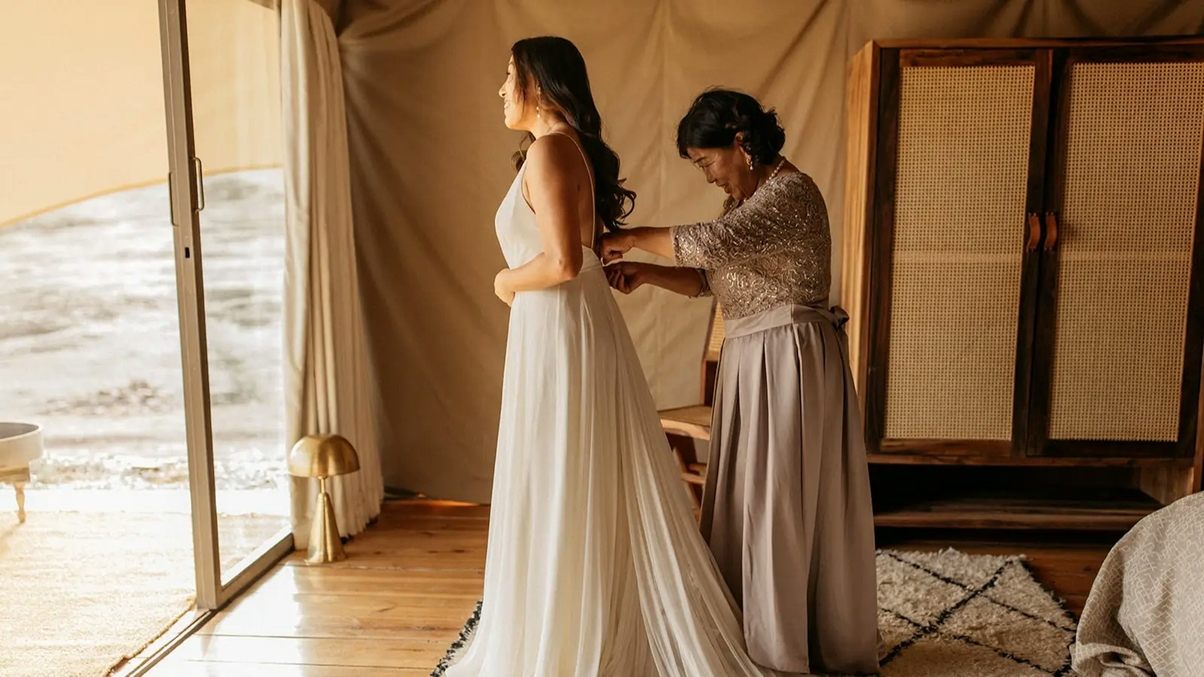 Bride getting into wedding dress