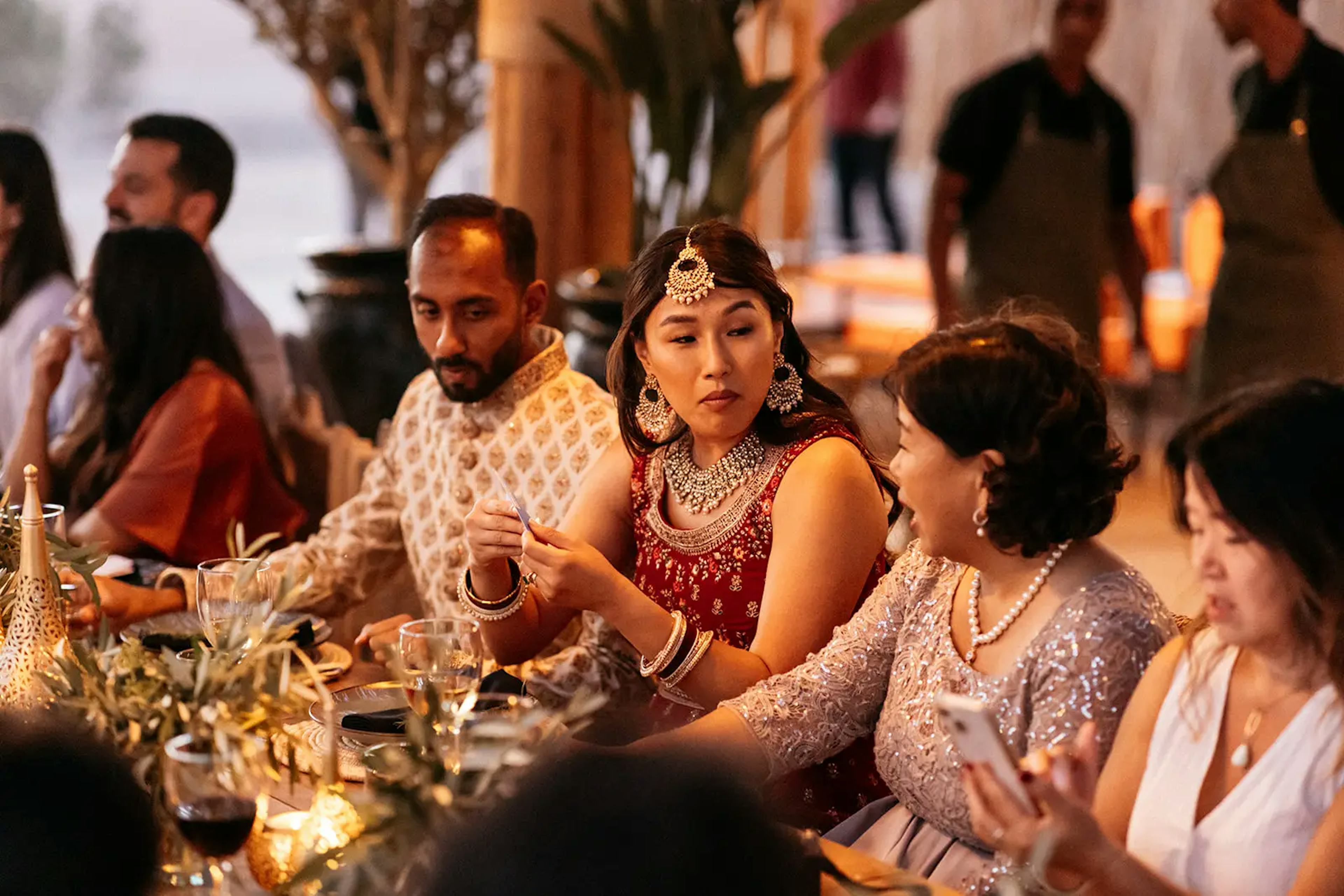 Bride with wedding guests at wedding reception