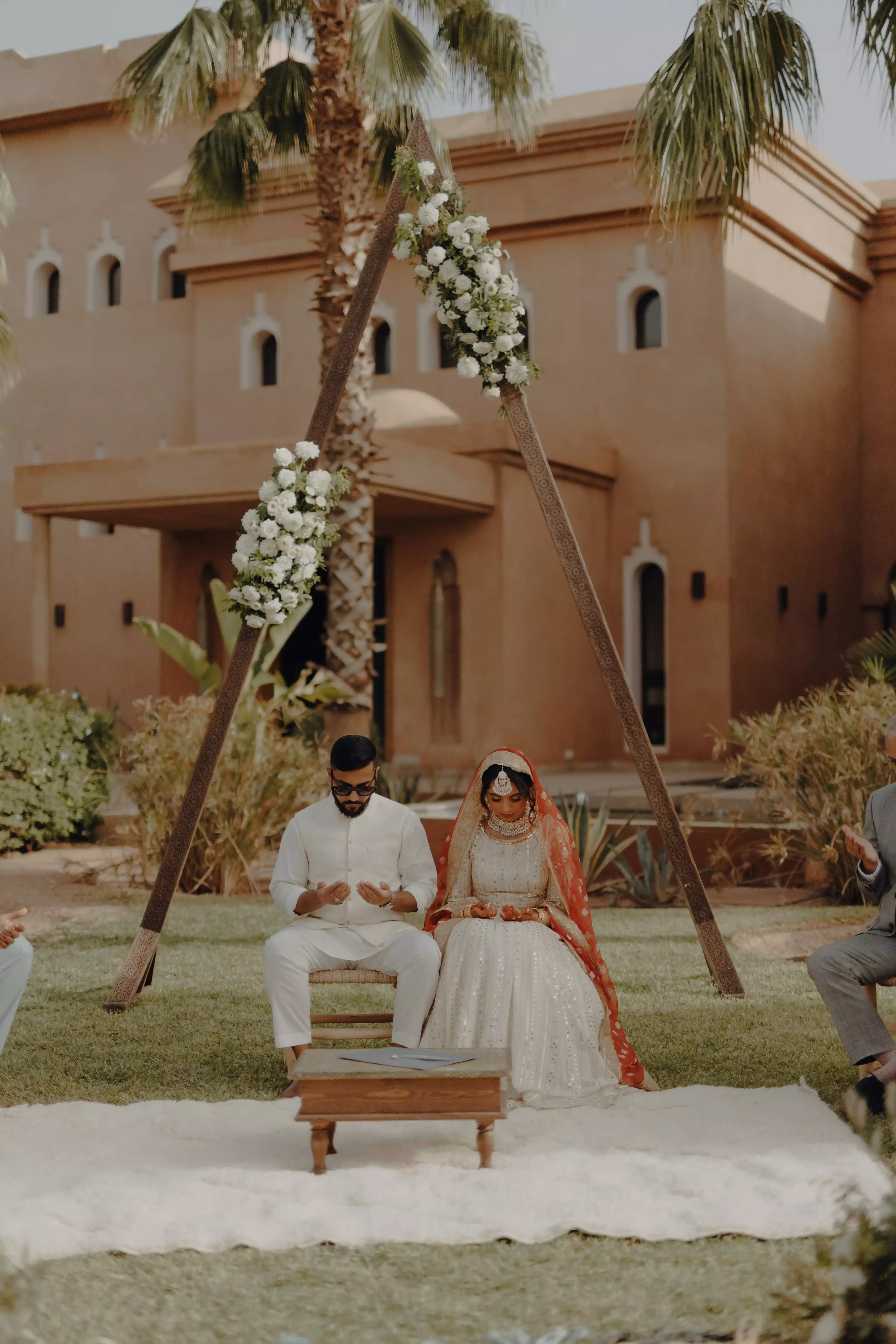 Couple sitting in front of backdrop