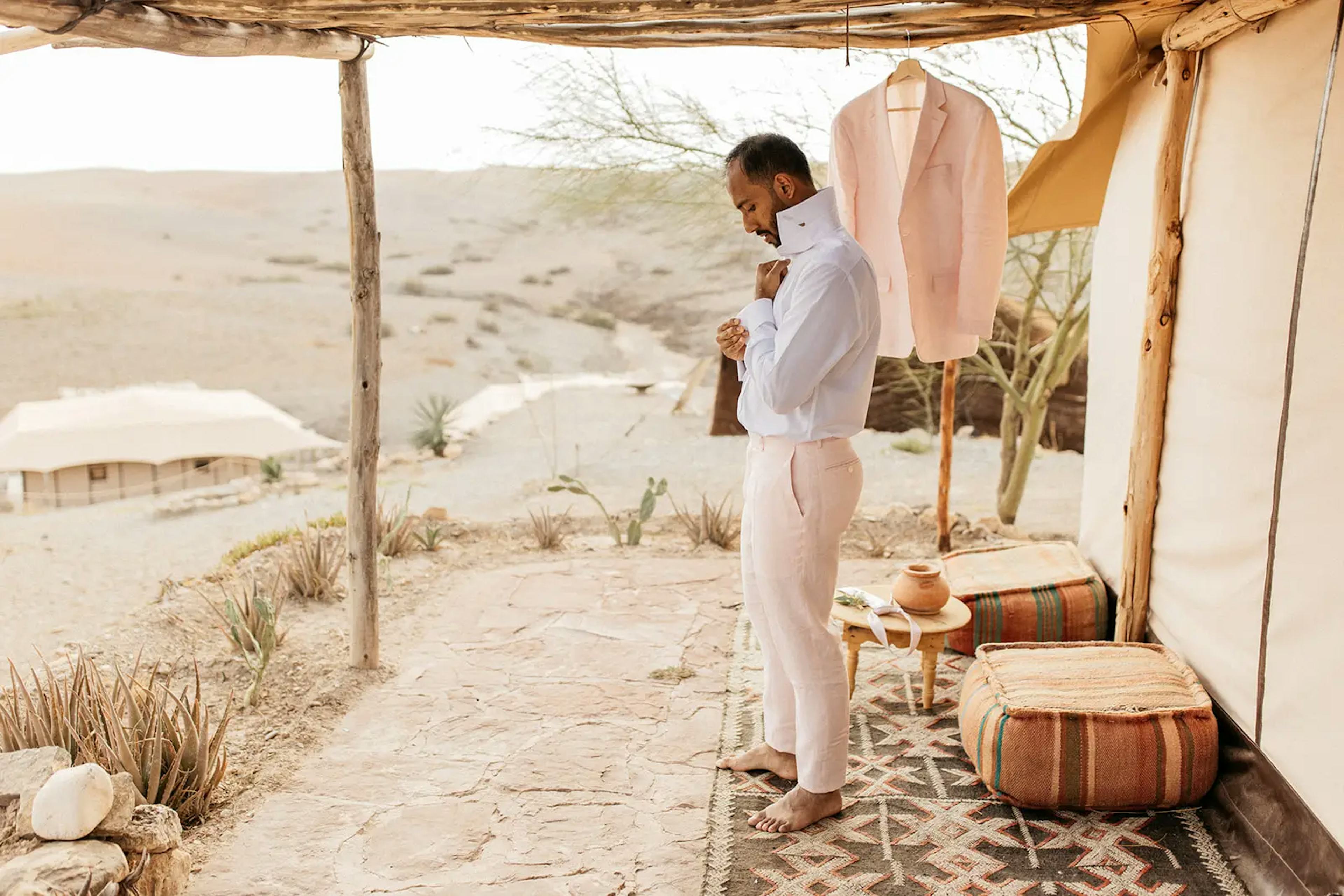 Groom getting dressed in agafay desert