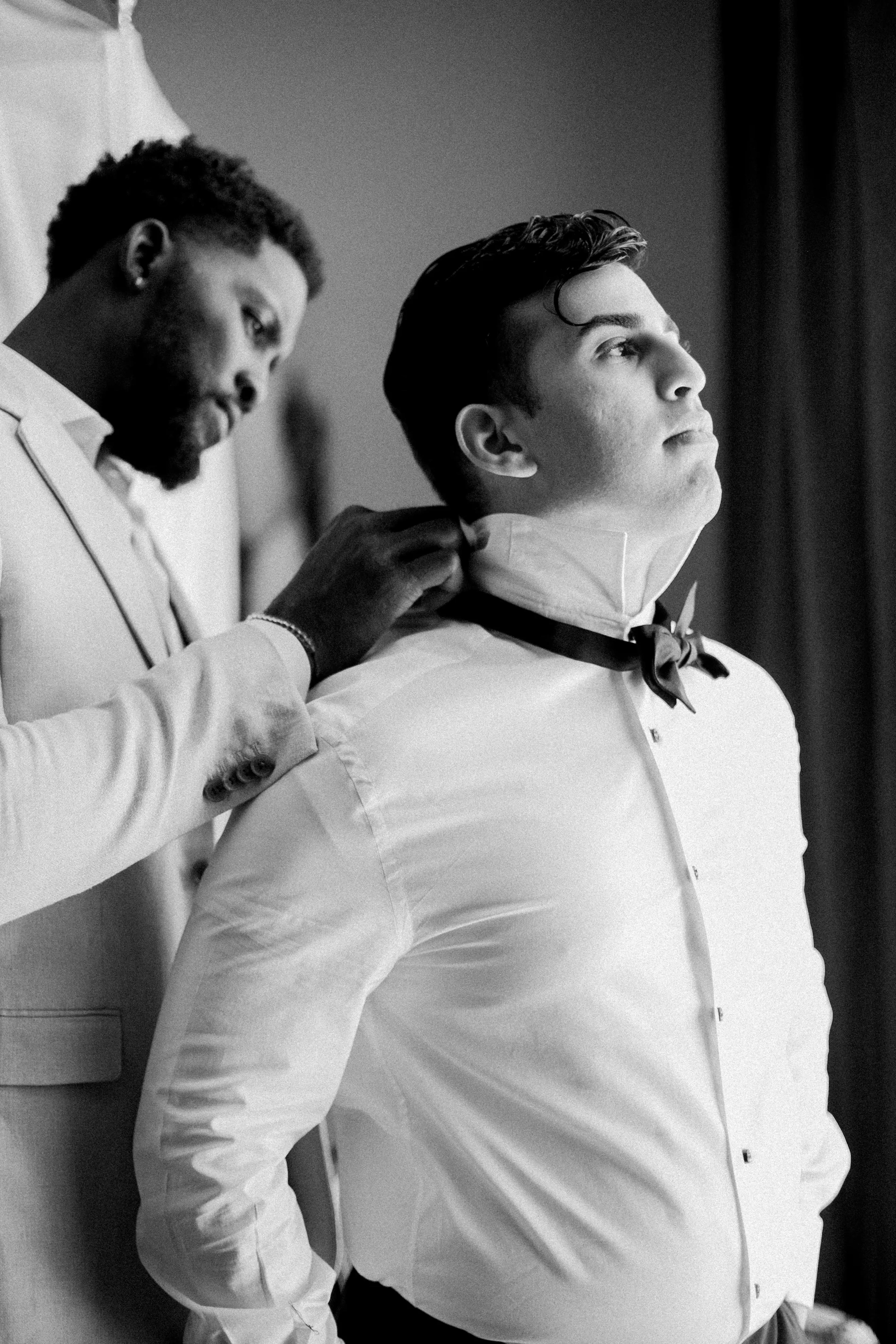 Groomsmen getting dressed on wedding day