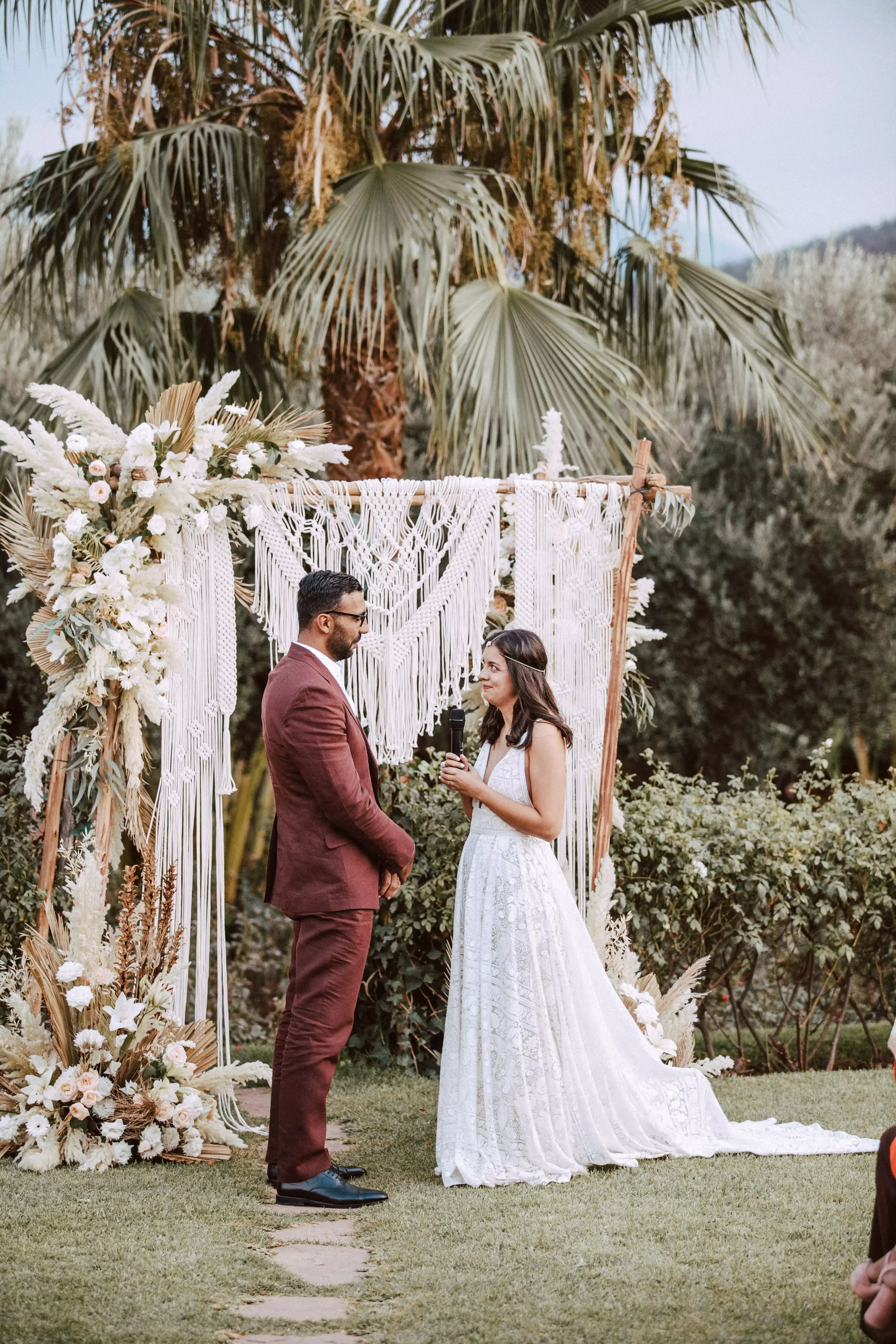 Couple saying vows in outdoor wedding ceremony