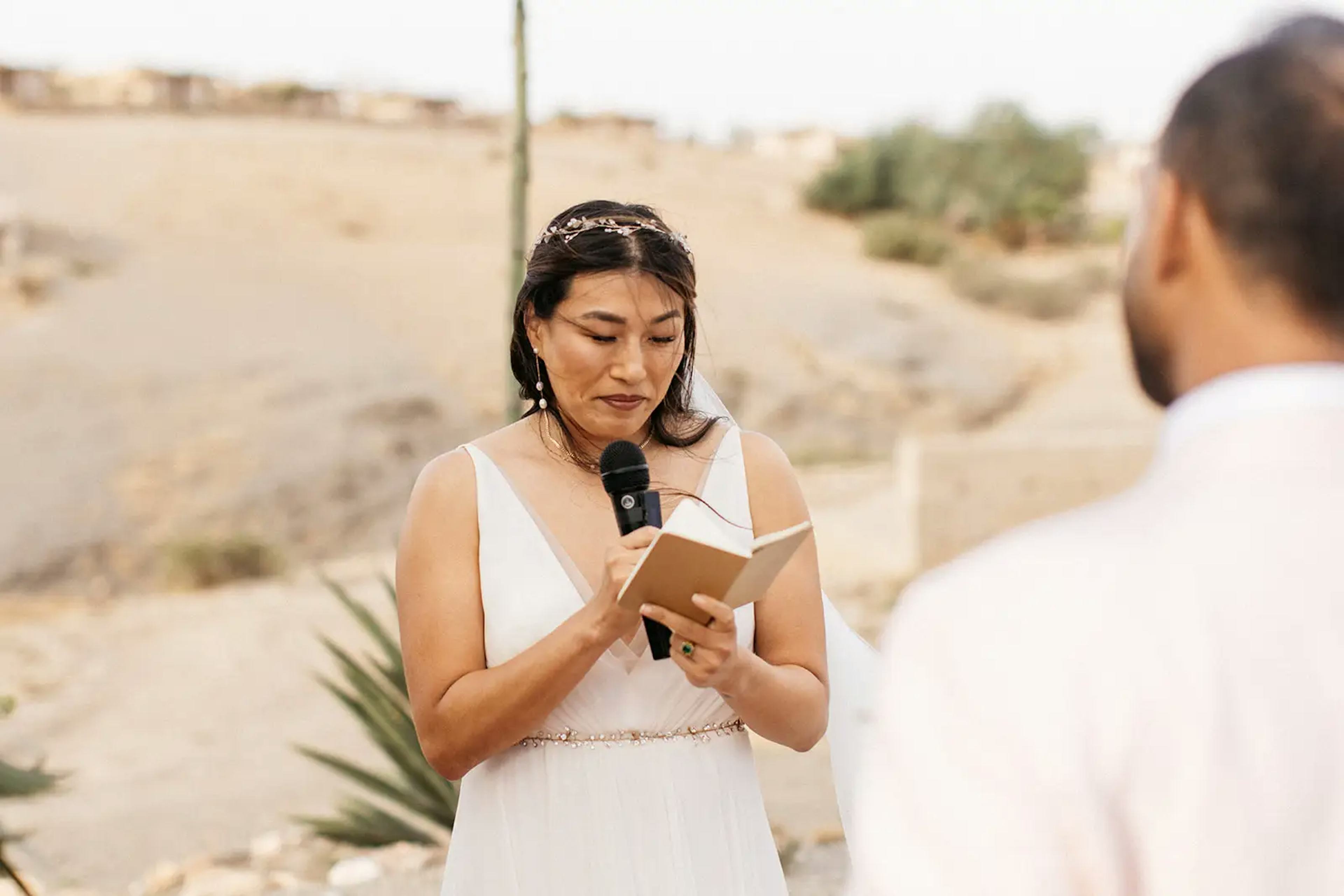 Reading wedding vows at outdoor wedding