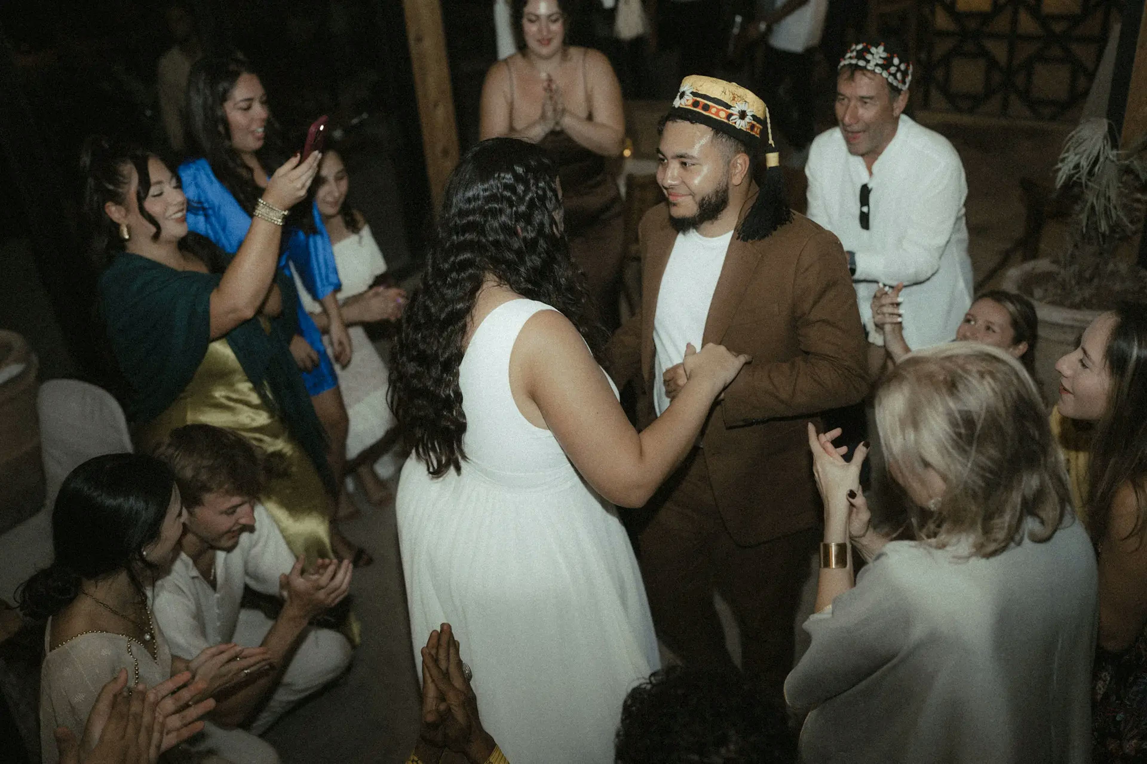 Spouses on the dance floor surround with their guests 